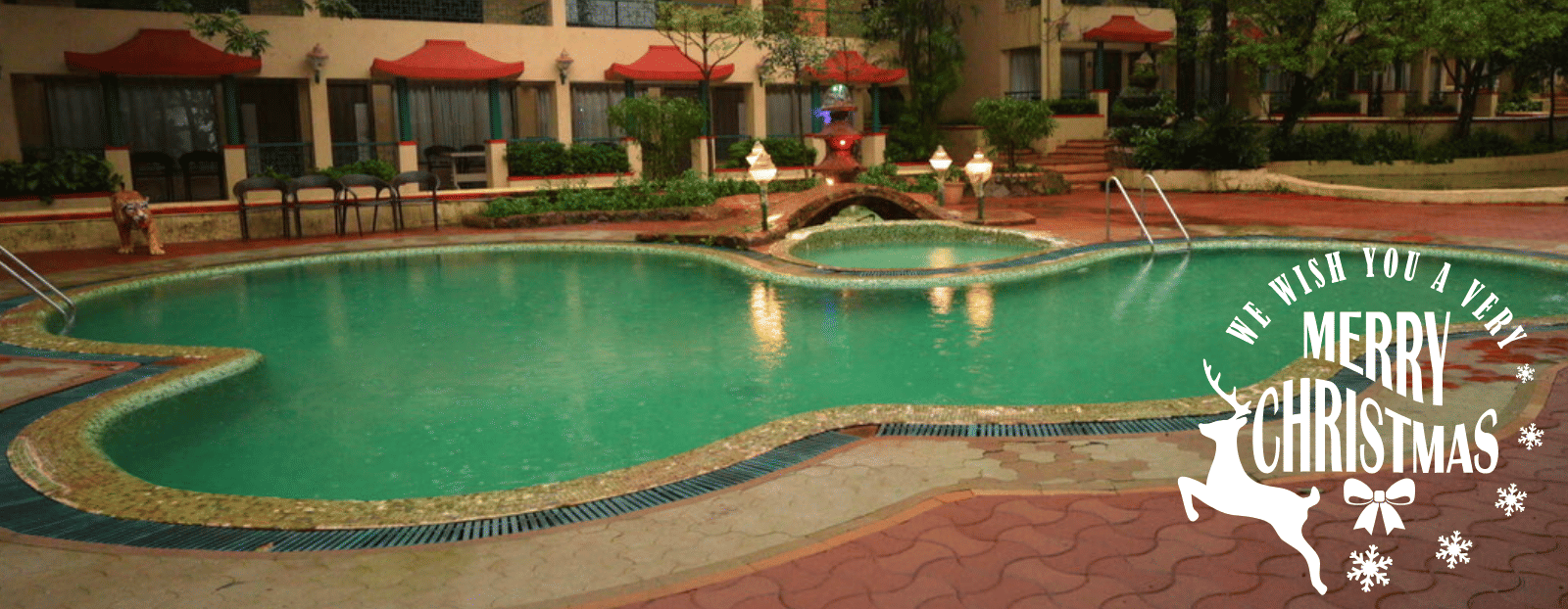A Christmas celebration poster for the hotel with an image of the pool and hotel building.