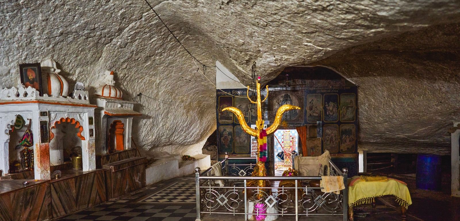 image of a temple site featuring a trishool in the middle