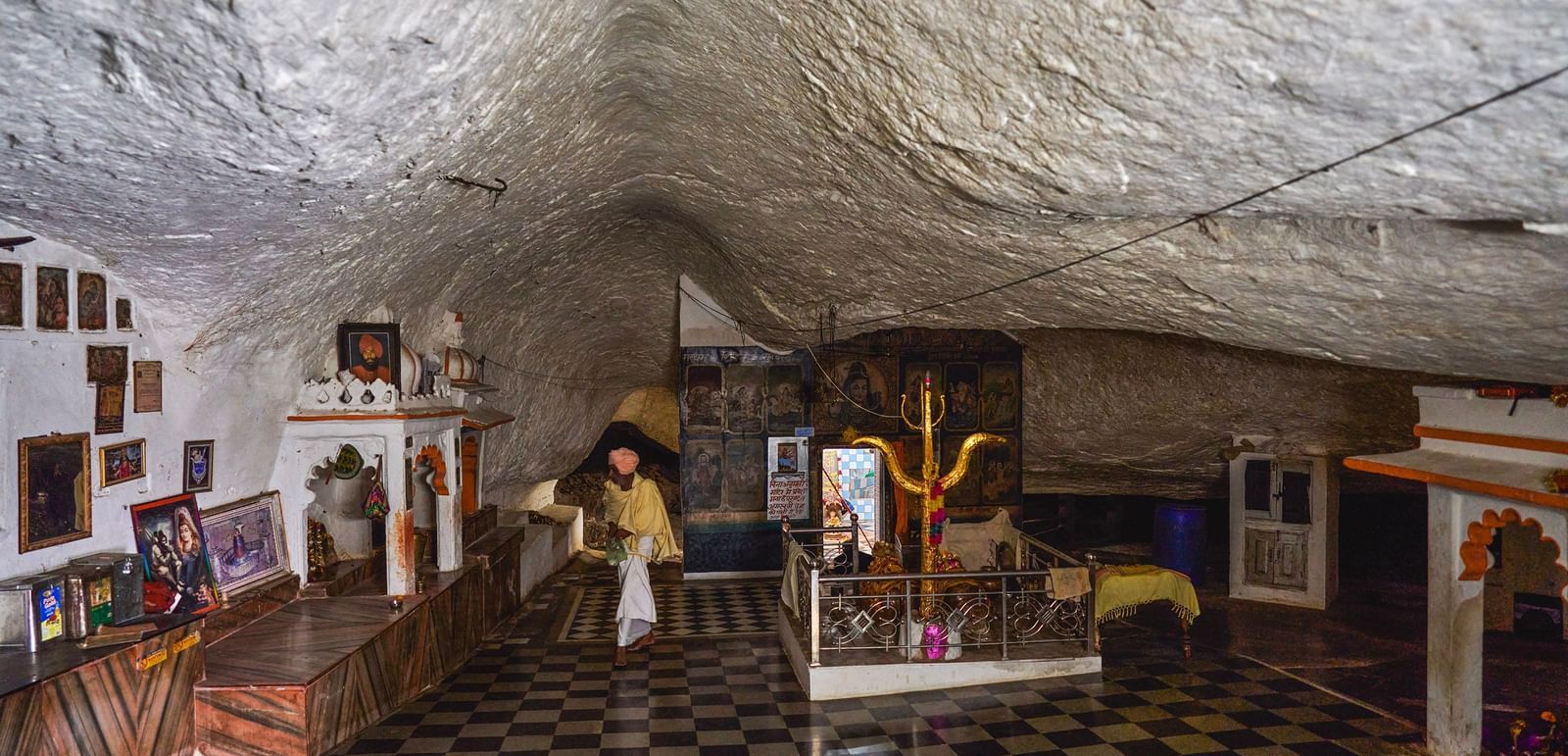 image of a pilgrim site constructed inside a cave with white coloured ceiling at the top