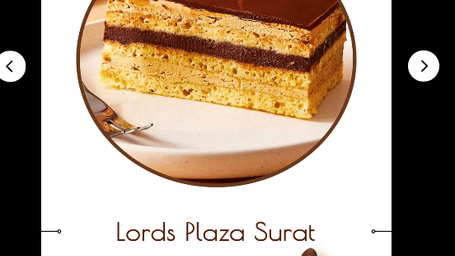 A poster featuring an opera cake with the text Lords Plaza Surat.