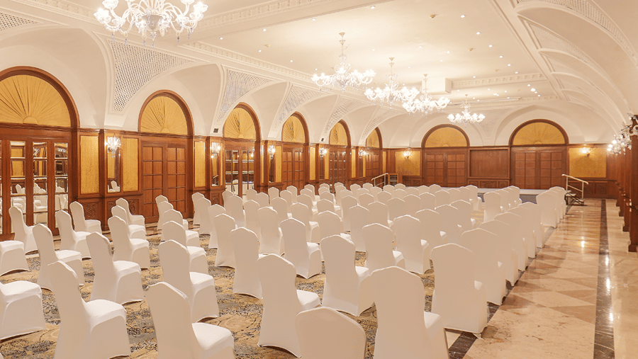 A side angle view of the Town Hall at The Residency Tower, Chennai, showcasing a floating crowd seating arrangement. The space is illuminated with bright lighting, enhancing the vibrant atmosphere for events and gatherings.