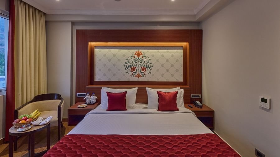a front view of the king size bed at the Deluxe Room - Golden Tulip, Tirupati