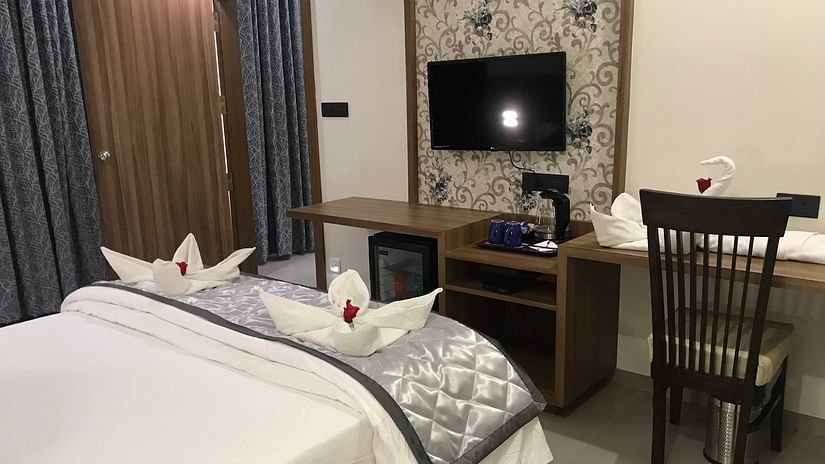 Suite With Breakfast room featuring a bed, desk, chair and TV | Kyriad Hotel, Solapur