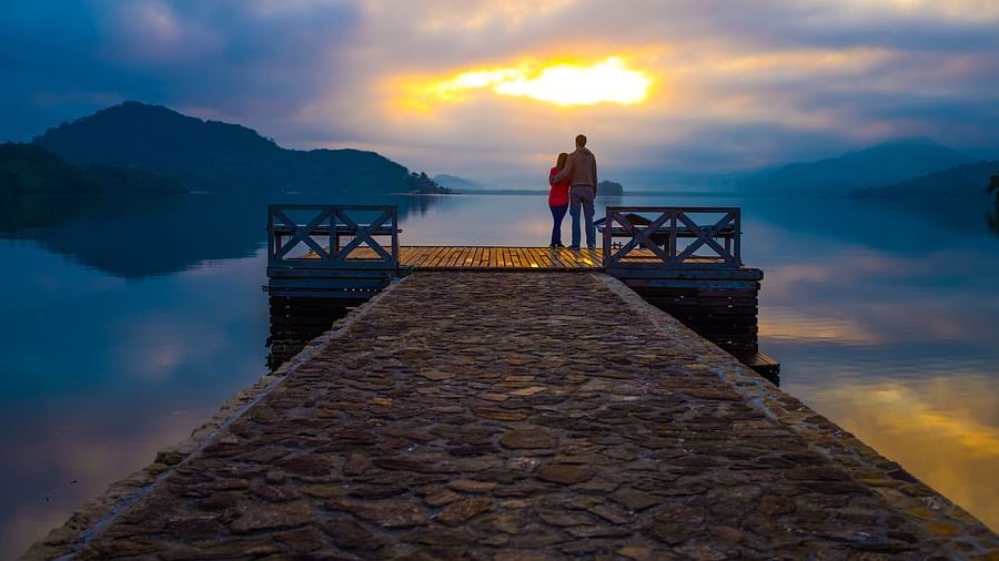 a couple enjoying the sunset from a jetty