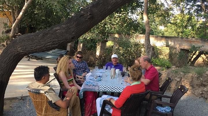 People enjoying a meal in the field - Dev Shree, Deogarh