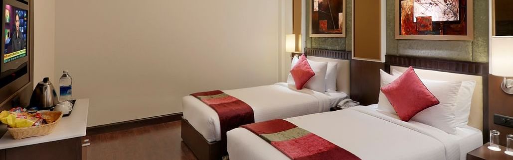 view of twin bed in Premium twin room of Inde Hotel Vista Woods, Gurgaon 