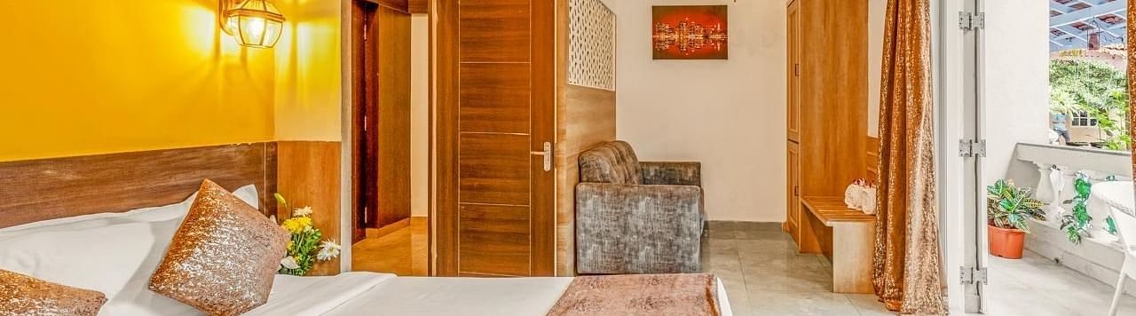Image of Junior Suite with a bed and a balcony in front at Calux Joia Do Mar Resort, Goa