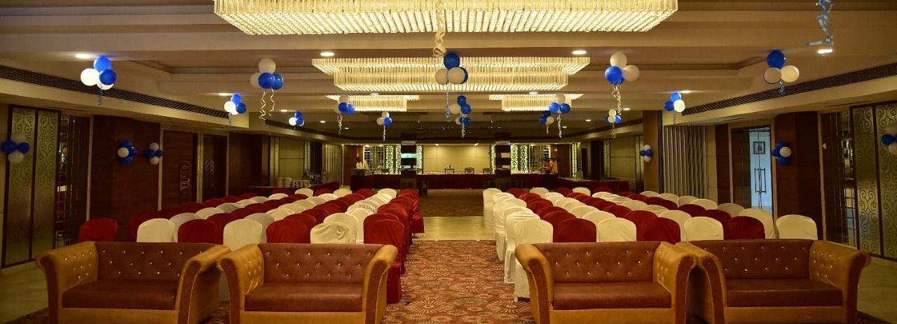 A banquet hall at Rang Lords Inn, with theatre style seating and decorated with blue and white balloons