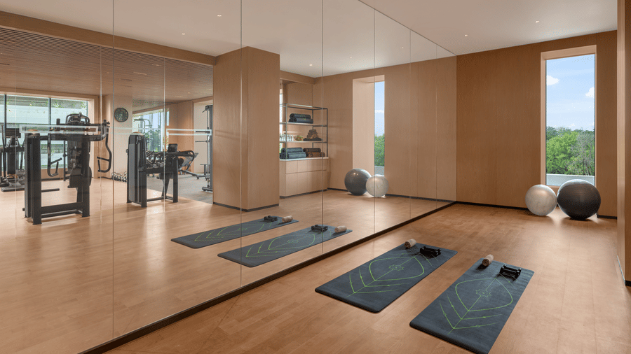 Fitness studio with yoga mats laid out on the floor and mirrored walls at The Residency Signature Madurai.