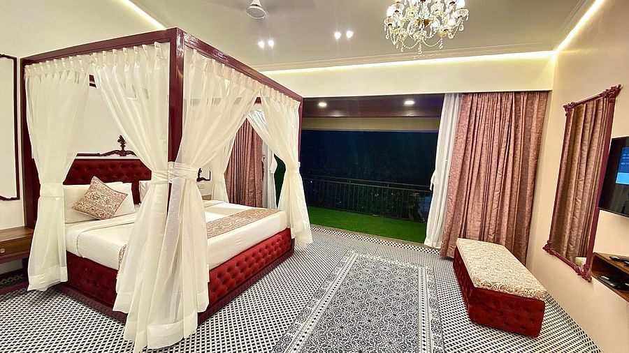 view of the bed and the room of Moghul from the lawn outside at nighttime 1 - Zara's Resort