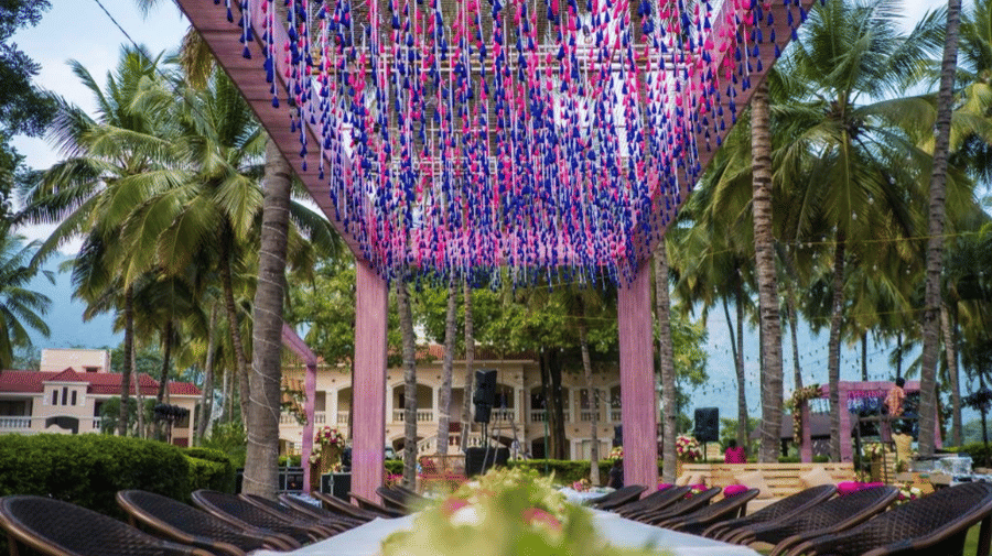 An event space Aura at Avana Resorts, featuring decorated chairs, tables, and a funky paper ceiling.