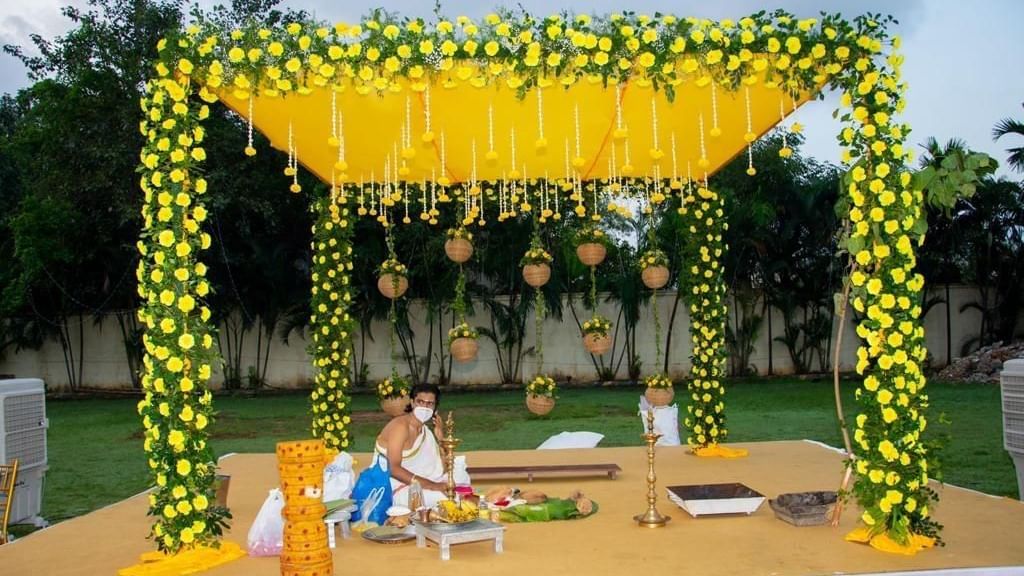 Close-up of a ceremonial mandap decorated with vibrant yellow flowers and hanging elements at Ilara Hotels & Spa, OMR, Chennai