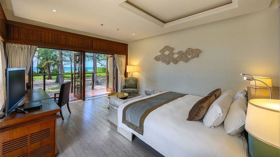 image featuring a king size bed overlooking beach front views from the open french windows - one bedroom private pool beachfront villa