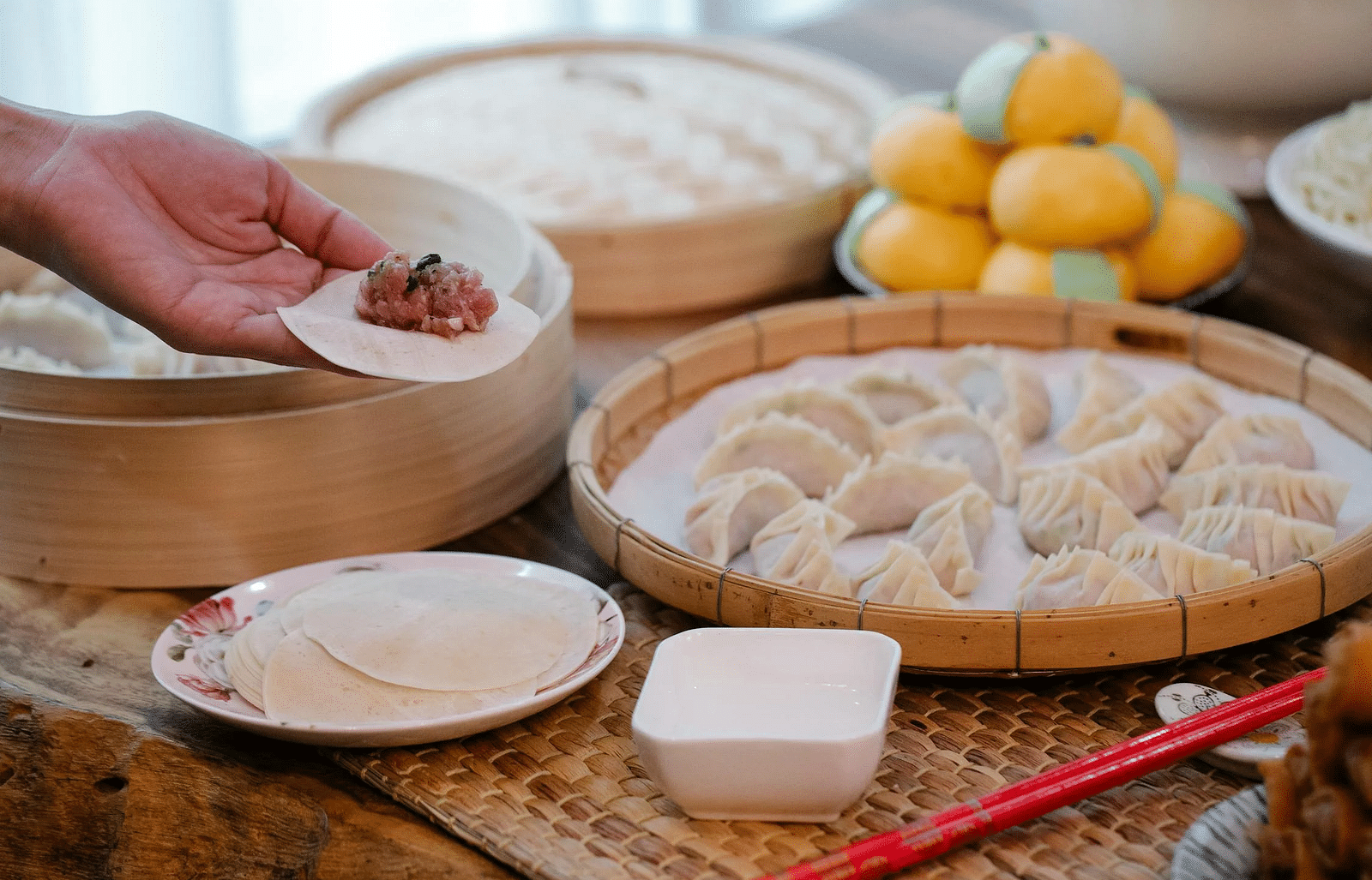 close up view of momos being prepared on bamboo baskets