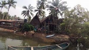 a boat floating on a water body surrounded by lush greenery.