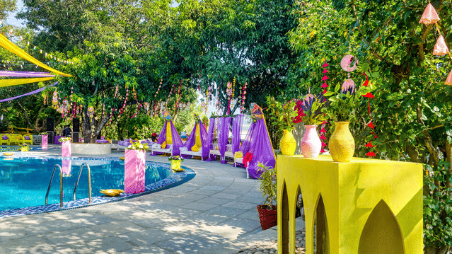 Festive poolside wedding venue with colorful decorations.