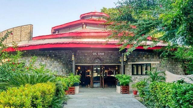 Resort entrance with distinctive red roof and well-maintained landscaping.