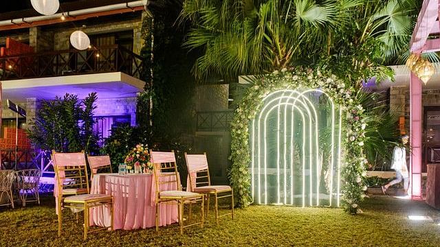 alt-text Festive outdoor space with string lights and lanterns.