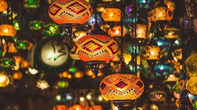 A vibrant display of traditional, multicoloured lanterns, glowing warmly in ambient lighting.