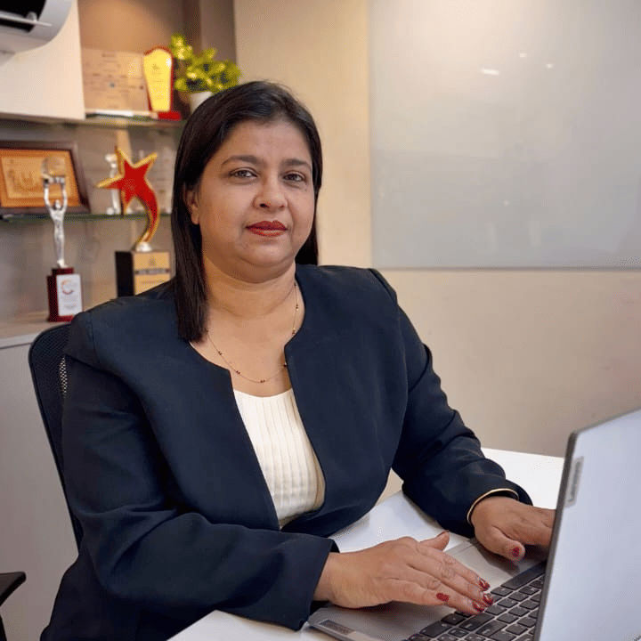 Ruchita Adate - Vice President Sales sitting indoor with the laptop in front of her