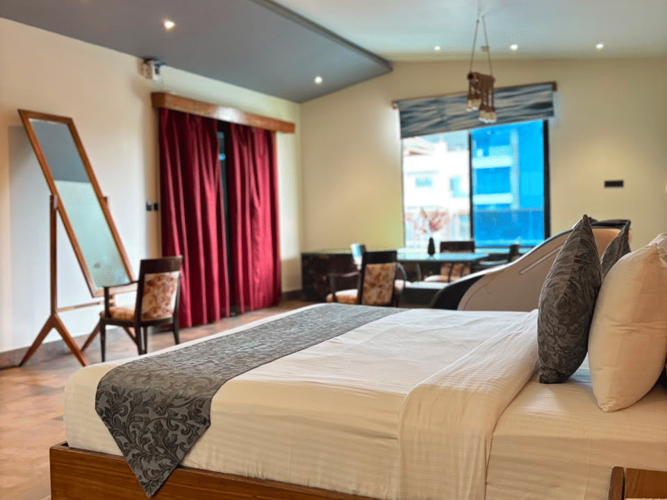 Emperor Room, King bed on the raised wood platform, with lounge chairs by the window