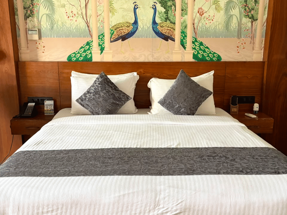 Emperor Room, Peacock mural above the headboard and bedside tables