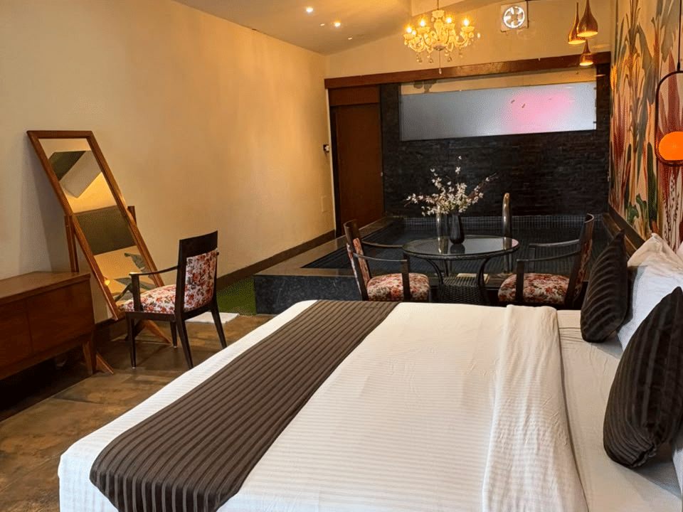 King Room, King bed on the wood platform beneath the chandelier