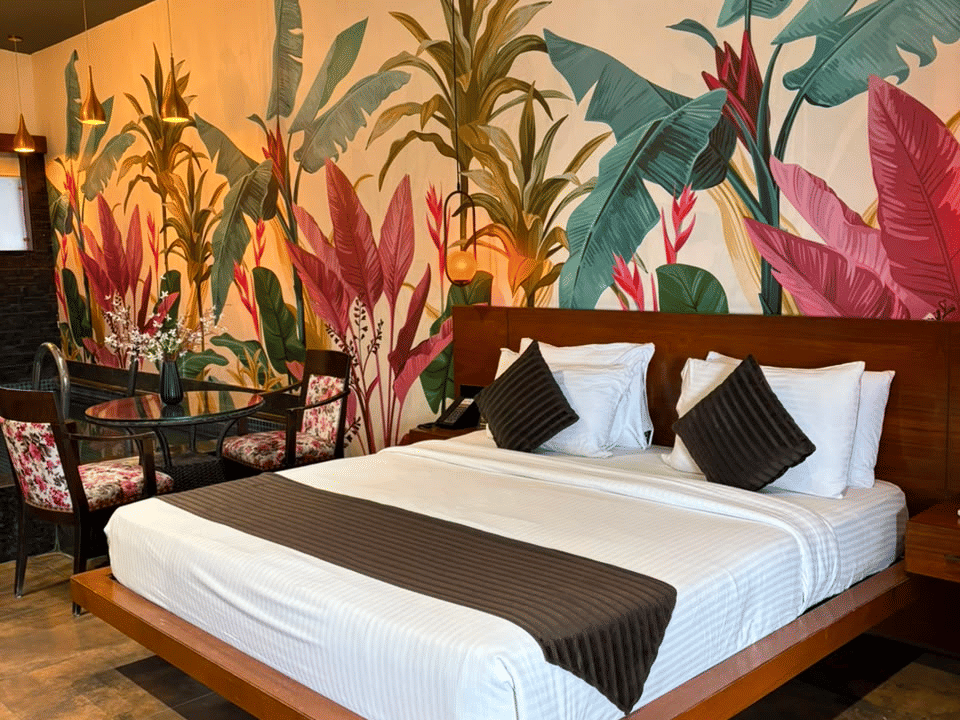King Room, King bed against the hand-painted banana-leaf mural