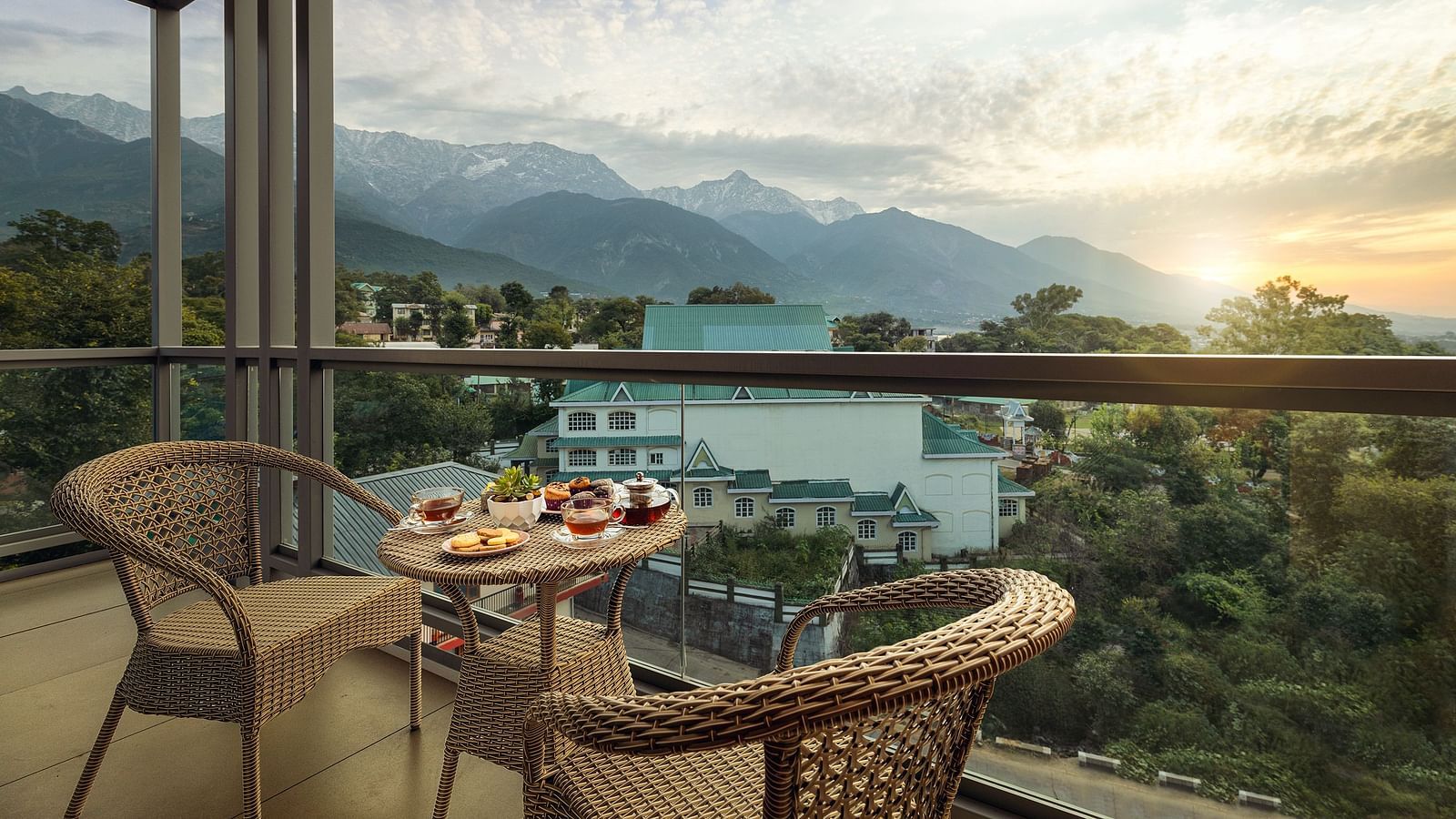 Premium peaks balcony area with a coffee table and chairs with mountains in the backdrop