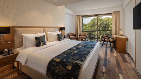 Superior Room at Infinitea Centric, Dharamshala with a double bed, television and a balcony