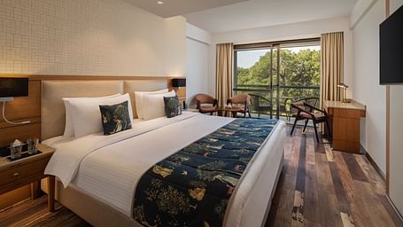 Superior Room at Infinitea Centric, Dharamshala with a double bed, television and a balcony