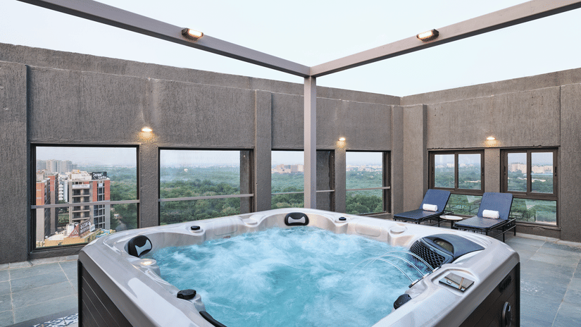 Rooftop outdoor Jacuzzi with panoramic city views - Pride Elite Gandhinagar