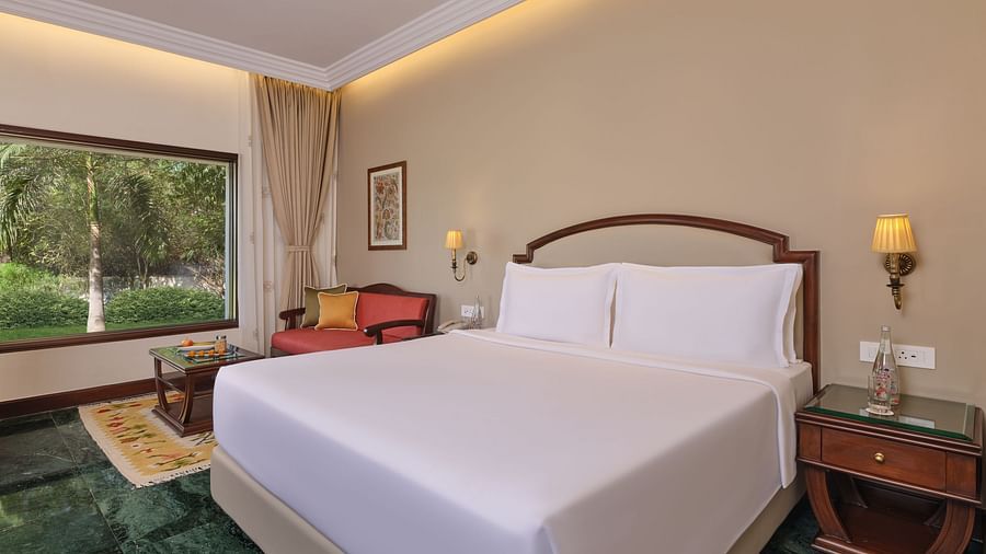 The Premium King Garden View Room at The Ummed Ahmedabad features a plush king size bed, elegant decor, and a scenic garden view