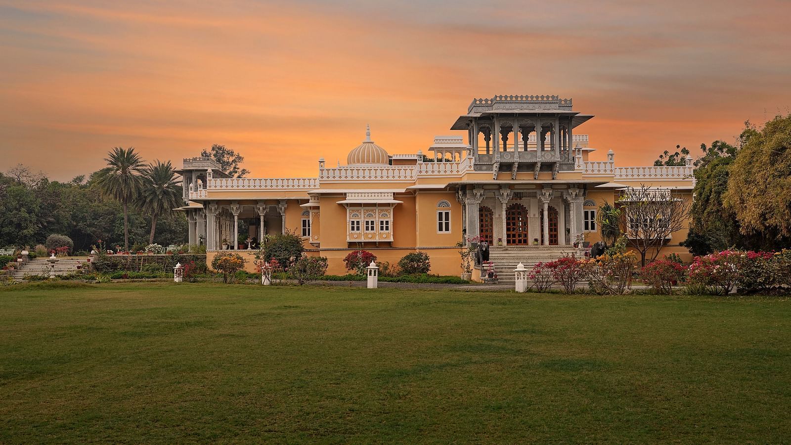 facade image of dev shree, deogarh with a sunset in the background
