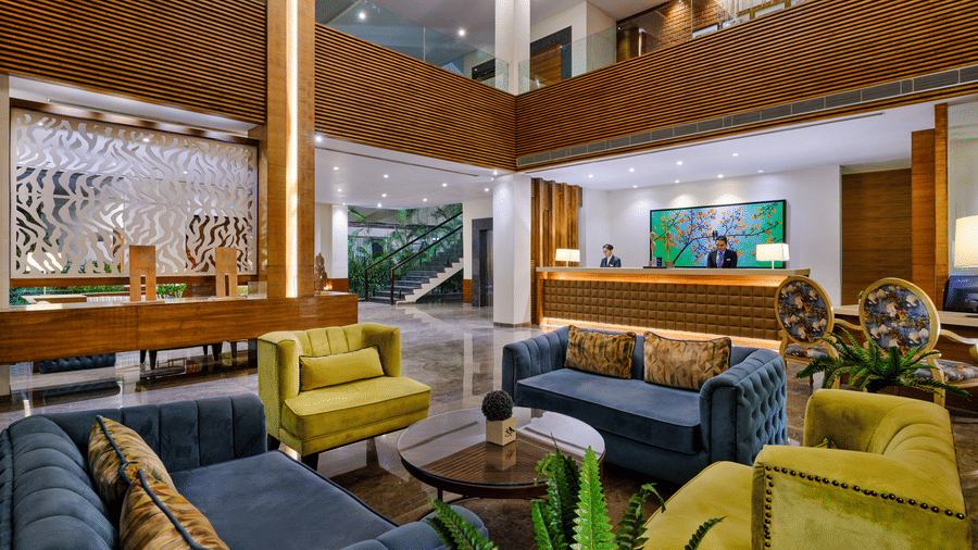 Image of the lobby at the hotel with several colourful couches 