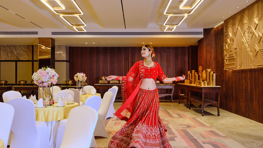 Image of  lady twirling in her bridal lehenga inside the banquet hall | Best Western Country Woods Hotels and Resorts