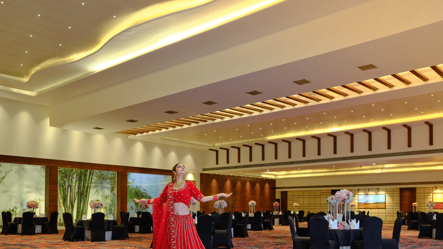 Shot of a women dressed in bridal attire inside the banquet hall of the hotel | Best Western Country Woods Hotels and Resorts