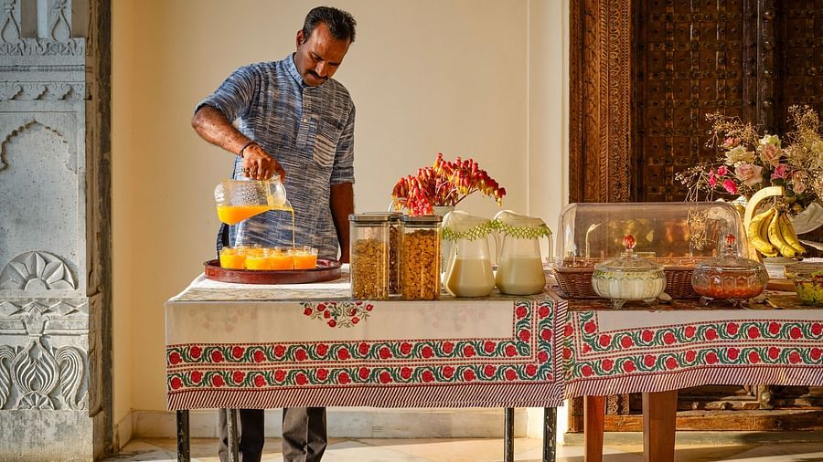 image of a man pouring orange juice at dev shree, deogargh