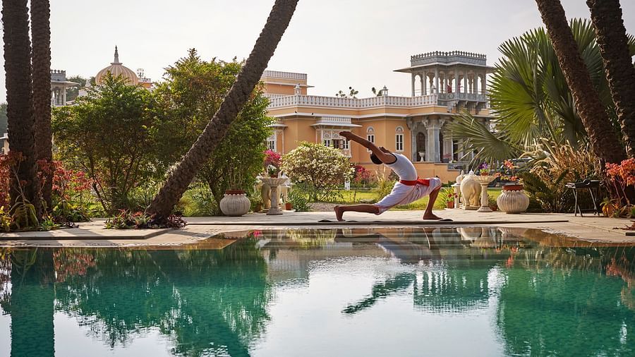 image of a man performing yoga at the poolside at dev shree deogarh