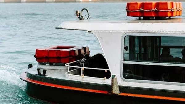 A boat moves through the water on an overcast day.