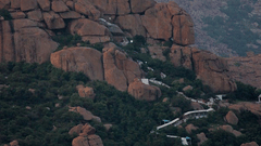 A pilgrimage path leads to a temple on a mountain peak.