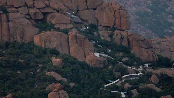 A pilgrimage path leads to a temple on a mountain peak.