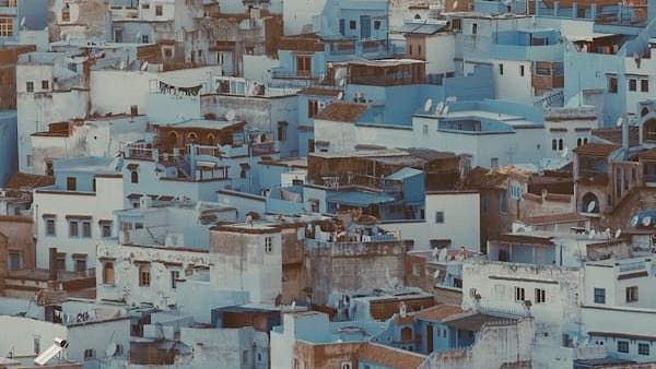 Aerial shot of a city with white buildings during the day