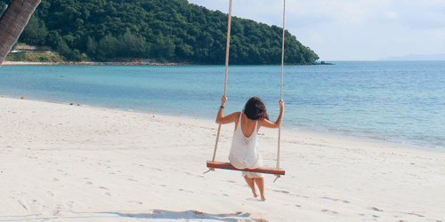 woman swinging on the beach