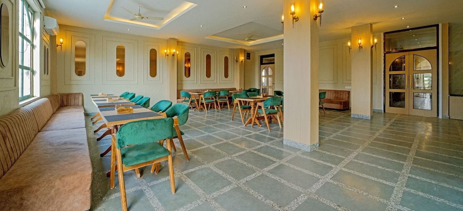 Dining area at Grassfield Riveria Resort, Jaipur, featuring stylish seating, soft lighting, and a spacious, elegant atmosphere.