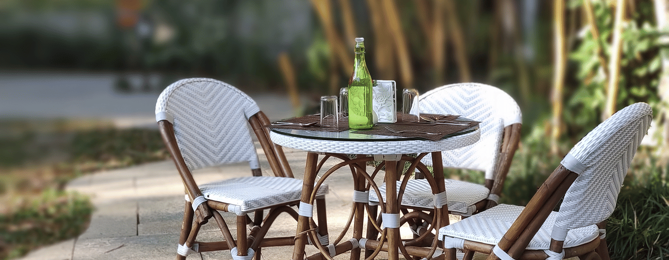 Outdoor patio with chairs and a bottle on the table-Amanvana Spa Resort, Coorg - Luxury Resort