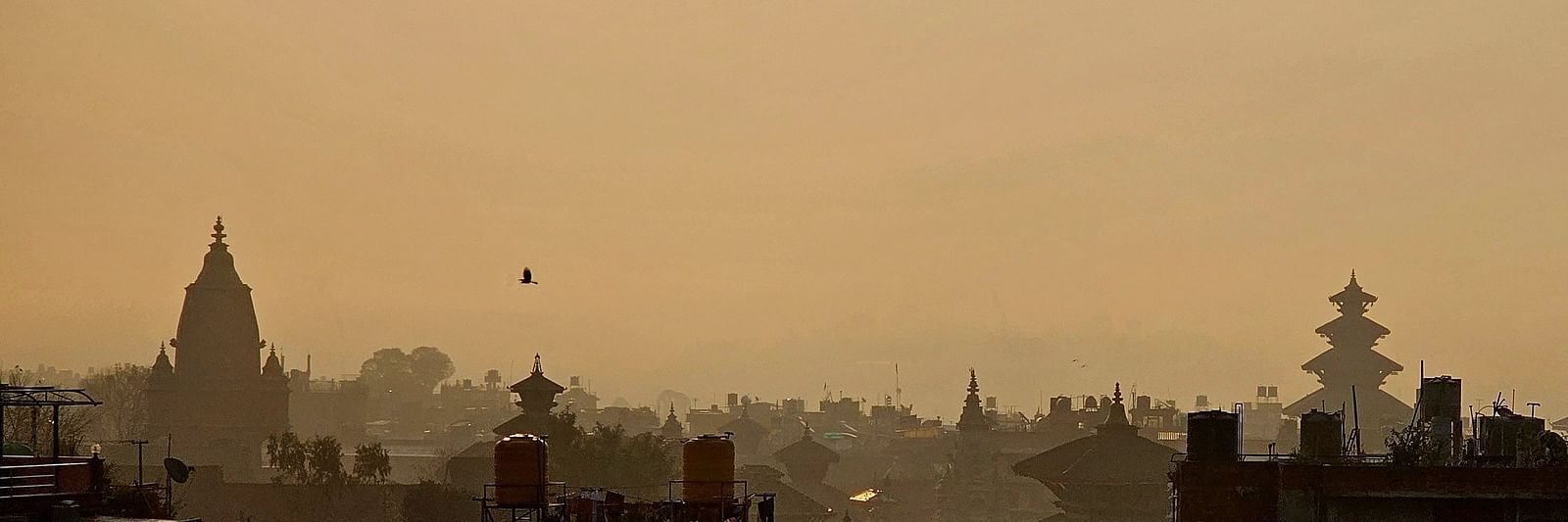The rooftop offers a city view with the silhouette of buildings against the skyline.