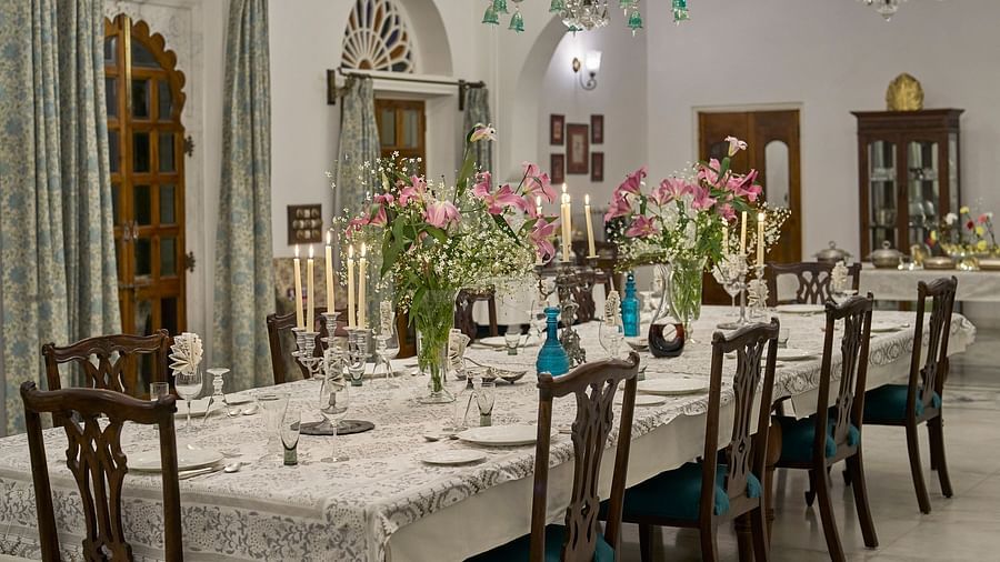 image highlighting the long dining table decorated with flowers and candles at dev shree, deogahr