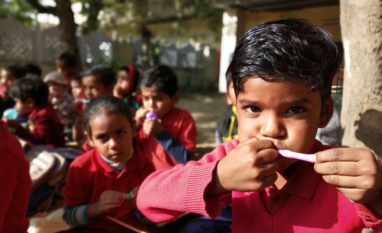 A boy trying to blow a balloon- Shahpura Bagh.