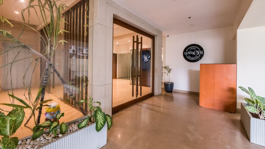 A bright reception area with modern decor and lush indoor plants, creating a welcoming atmosphere at Shilton Dee Cee.